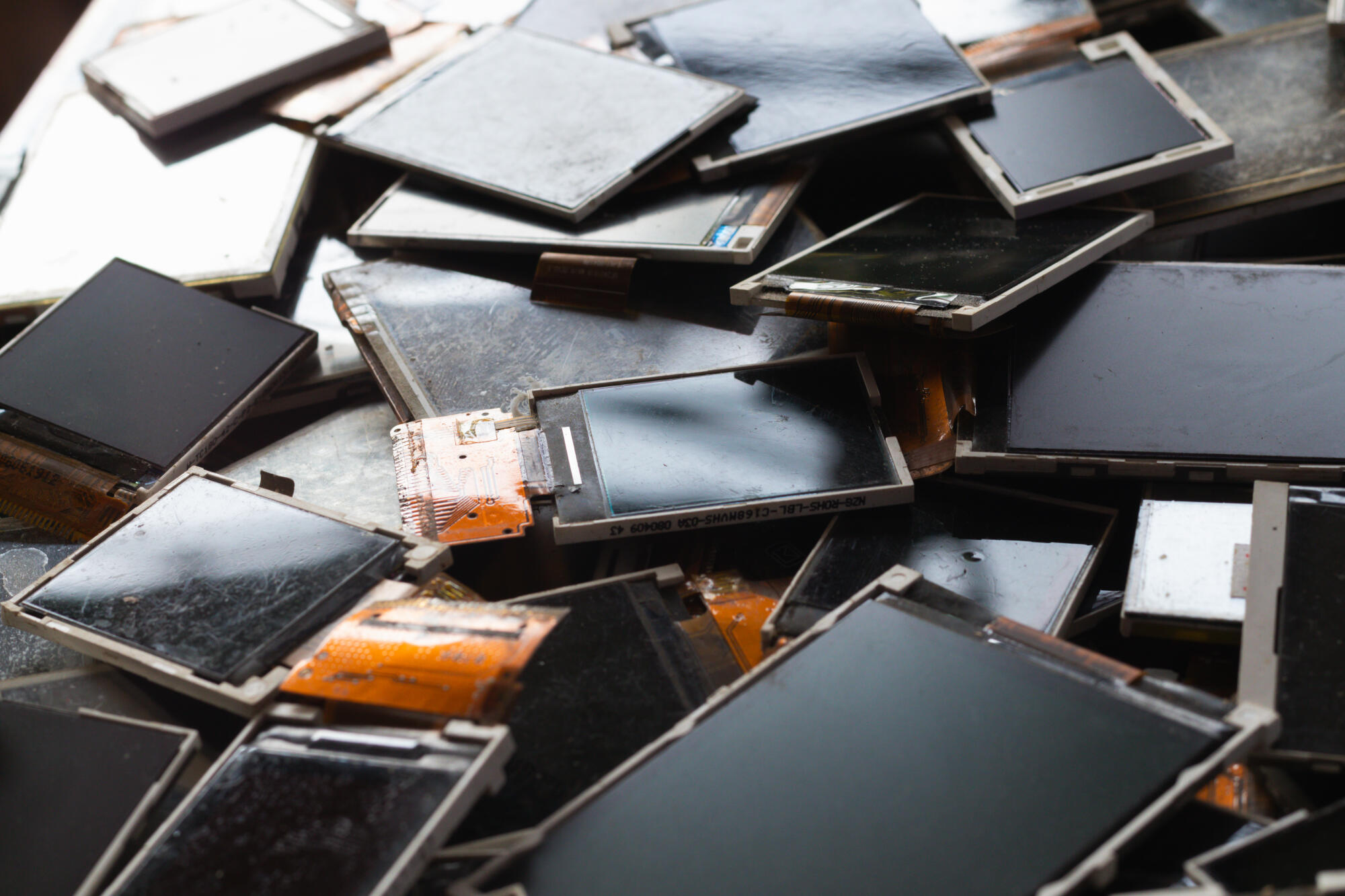 Damaged LCD screens of mobile phones are collected as electronic waste waiting for valuable metals inside LCD screens - The MAD Junk Man Merrimack NH 03054